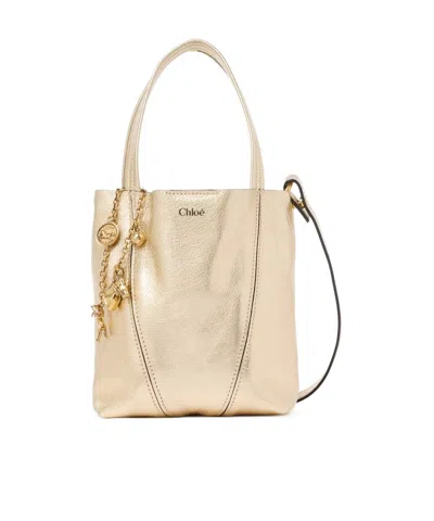 Chloé Small Chloe Spin Tote Bag In Metallic Leather With Horse Charms In Blue