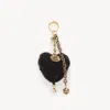Chloé Symbols Heart Shearling Bag Charm In Brass In Black