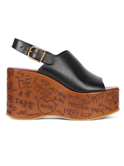 Chloé Maxime Black Wedge With Engraved Written Decorations And Logo Buckle In Leather Woman