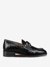 Christian Louboutin Chambelimoc Croc-embossed Loafers In Detail Of A Bold Silver Brooch On The Neck.