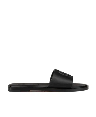 CHRISTIAN LOUBOUTIN CHRISTIAN LOUBOUTIN LOGO EMBOSSED SLIP-ON SANDALS