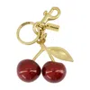 Coach Resin Cherry Bag Charm In Gold