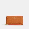 Coach Long Zip Around Wallet In Signature Canvas In Orange