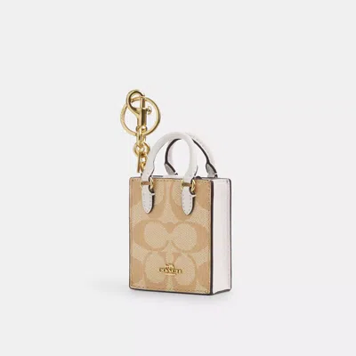 Coach North/south Mini Tote Bag Charm In Signature Canvas In Beige