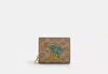 Coach Outlet Cosmic Coach Snap Wallet In Signature Canvas With Rexy Print In Beige
