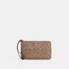 Coach Outlet Large Corner Zip Wristlet In Signature Canvas In Beige