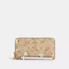 Coach Outlet Long Zip Around Wallet In Signature Canvas With Floral Print In Beige