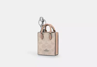 Coach Outlet North/south Mini Tote Bag Charm In Signature Canvas In Beige