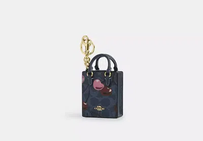 Coach Outlet North/south Mini Tote Bag Charm In Signature Canvas With Cherry Print In Blue/multi