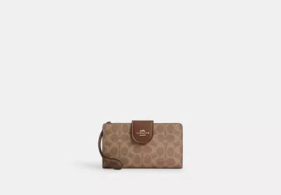 Coach Outlet Phone Wallet In Signature Canvas In Brown