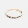 COACH OUTLET SIGNATURE ENAMEL HINGED BANGLE