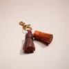 Coach Remade Colorblock Tassel Bag Charm In Orange Brown
