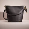 Coach Restored Dakota Bucket Bag In Brass/black