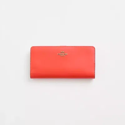 Coach Restored Skinny Wallet In Brass/red Orange