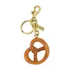 Coach Kleiner Taschenanhänger Brezel In Gold