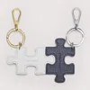COCCINELLE LEATHER AND METAL KEY RING PUZZLE