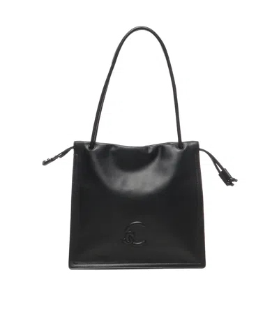Coccinelle Logo Embossed Drawstring Tote Bag In Black