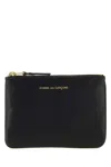 Comme Des Garçons Debossed Logo Zipped Wallet In Black