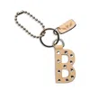 Consuela Iced "b" Bag Charm In Brown In Brown
