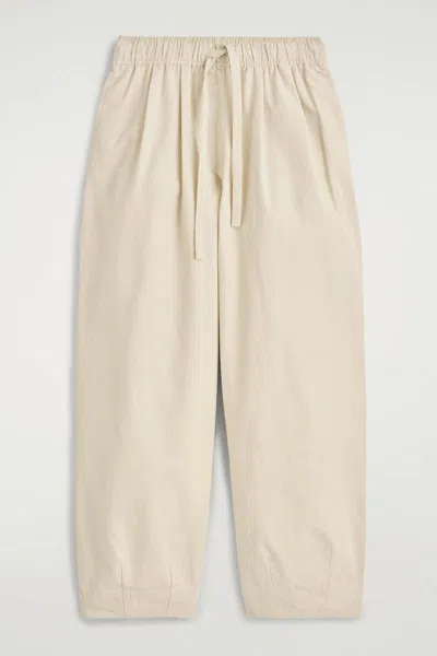 Cos Cotton Tapered Drawstring Trousers In Beige In Sand