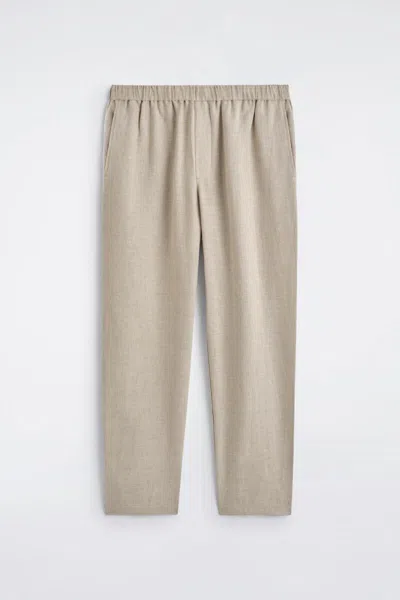 Cos Elasticated Linen Regular-fit Tapered Trousers In Beige In Sand