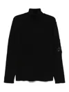 C.p. Company Ribbed Knit Roll Neck Sweater With Signature Lens Detail And Zip Pocket In Black