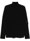 C.p. Company Ribbed Knit Roll Neck Sweater With Signature Lens Detail And Zip Pocket In Black