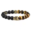 Crucible Jewelry Crucible Los Angeles Single Gold Skull Stretch Bracelet With 10mm Matte Black Onyx And Tiger Eye Bea In Gold