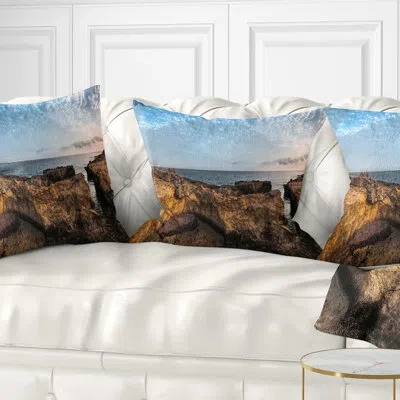 Design Art Rough Rocky Coast Under Blue Sky - Sea & Shore Printed Pillow In Brown;orange