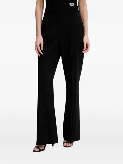 Dkny Pressed-crease Logo-plaque Trousers In Black