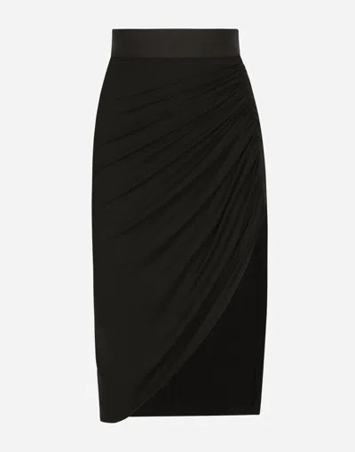 DOLCE & GABBANA ASYMMETRICAL JERSEY SKIRT WITH DRAPING