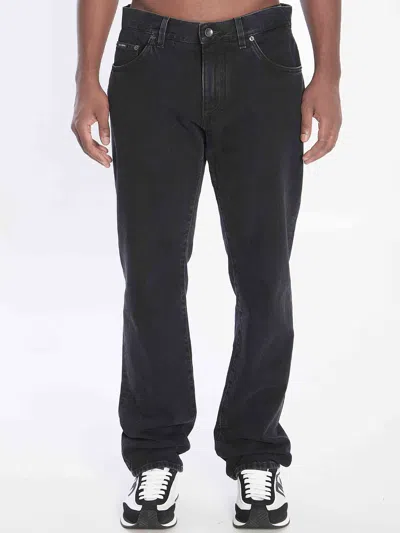 DOLCE & GABBANA DOLCE&GABBANA MEN DENIM PANTS WITH PLAQUE