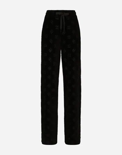 Dolce & Gabbana Flocked Jersey Pants With All-over Dg Logo In Black