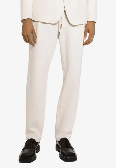 Dolce & Gabbana Logo Plaque Drawstring Track Pants In Cream