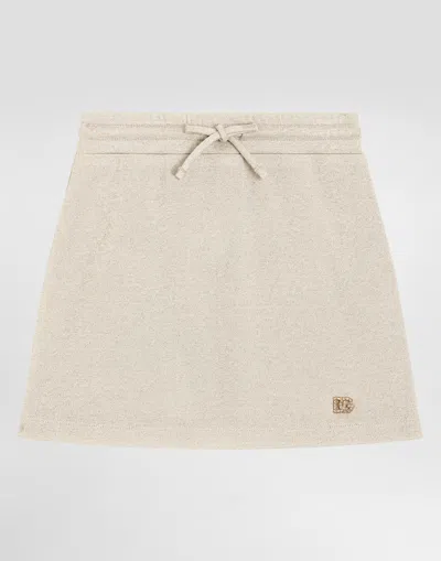 Dolce & Gabbana Lurex Jersey Skirt With Dg Logo In Gold