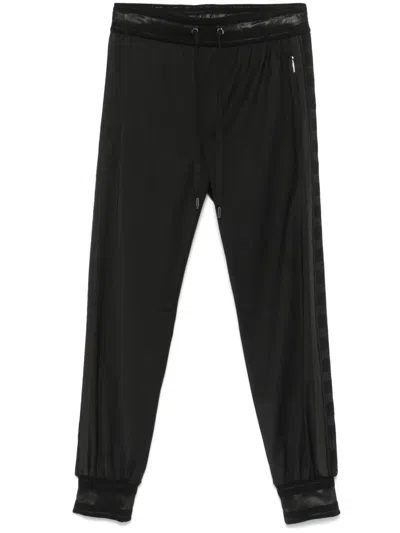 Dolce & Gabbana Pinstriped Tapered Trousers In Black