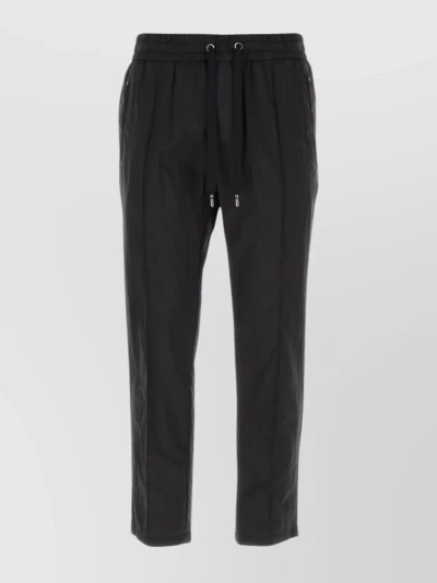 Dolce & Gabbana Pleated Nylon Tapered Trousers With Zip Pockets In Black