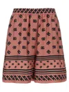 Dolce & Gabbana Pink Bermuda Shorts With Dg Logo Printed All-over In Silk Woman