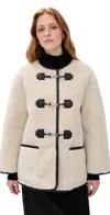 Dunst Collarless Buckled Shearling Jacket Cream In Neutral