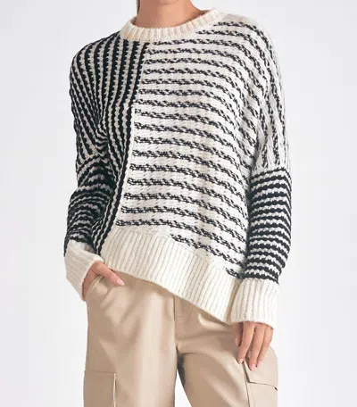 ELAN AYSMMETRICAL STRIPED SWEATER IN BLACK/WHITE
