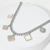 Fashnzfab 14k Gold Plated Cz Stone Paved Mother Of Pearl Quatrefoil Charm Station Necklace In Multi