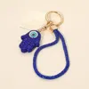 Fashnzfab Bling Studded Evil Eye Hamsa Hand Charm Keychain Bag Charm Phone Holder In Blue