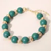 Fashnzfab Bold Wooden Textured Metal Ball Beaded Statement Necklace In Green