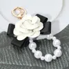 Fashnzfab Bow Rose Pointed Pearl Chain Link Keychain / Bag Charm In Gold