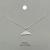 Fashnzfab Brass Metal Stone Paved Whale Tail Pendant Necklace In Metallic