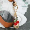 Fashnzfab Cherry Pearl Heart Key Cross Flower Charm Embellished Keychain / Bag Charm In Gold