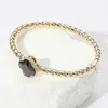 Fashnzfab Cz Quatrefoil Stone Accented Twisted Hinged Bangle Bracelet Gold, Jet Black In Multi