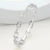 Fashnzfab Cz Stone Paved Horseshoe Buckle Hinged Bangle Bracelet Clear, Silver In Multi