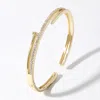Fashnzfab Cz Stone Paved Nail Cuff Hinged Bracelet In Gold