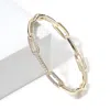 Fashnzfab Cz Stone Paved Paperclip Chain Hinged Bange Bracelet Gold In Gold